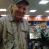 Actor Jeff Kirkendall holding up the JURASSIC PREY DVD at FYE!