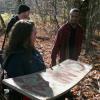 Christi (Kelsey Kaufmann) shows Harvey (Joshua Pollitt) and Victor (Houston Baker) the infamous Camp Blood sign in CAMP BLOOD FIRST SLAUGHTER from Polonia Brothers / Sterling Entertainment.